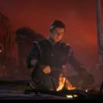 Cal Kestis and BD-1 from Star Wars Jedi Fallen Order meditate by a fire.